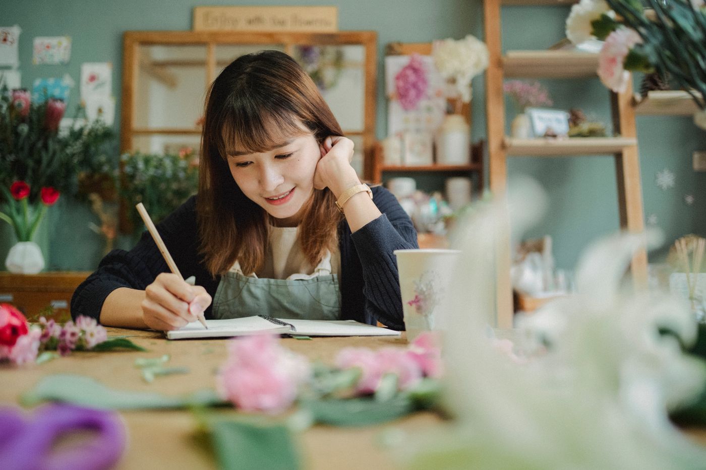 A small-business owner planning orders in her flower shop