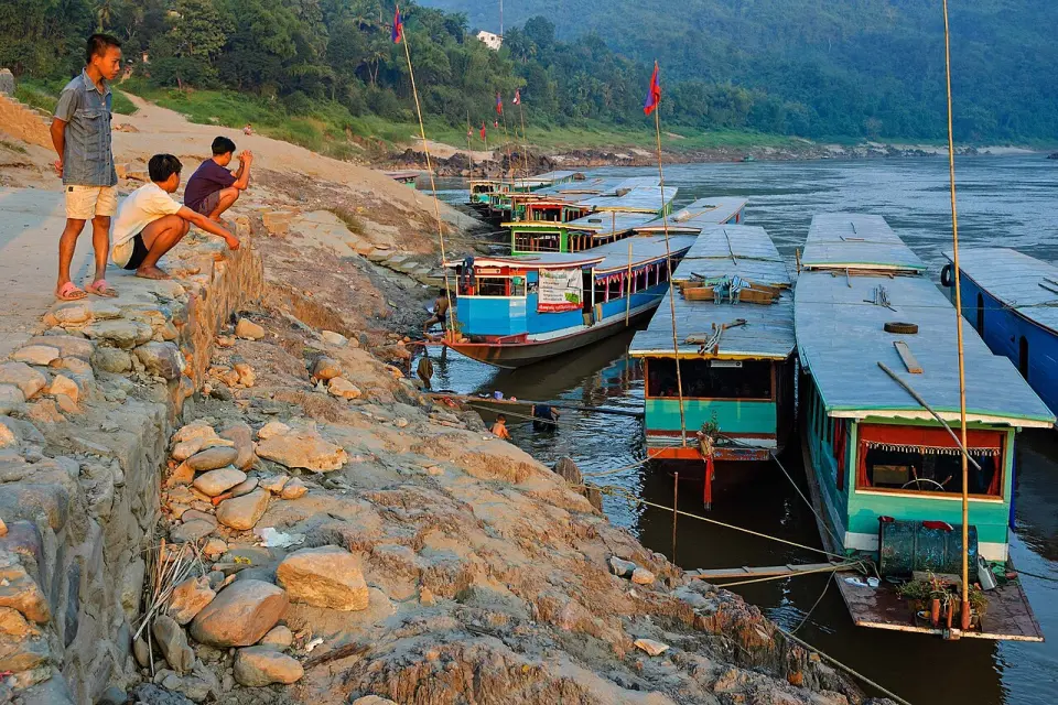 Slow boats moored on the Mekong at Pak Beng at sunset