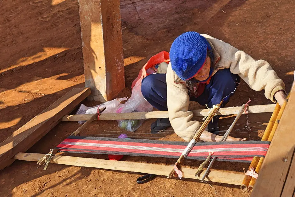 A weaver at a loom in Laos