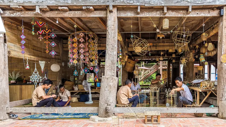 Craftspeople weaving bamboo baskets and textiles in Luang Prabang