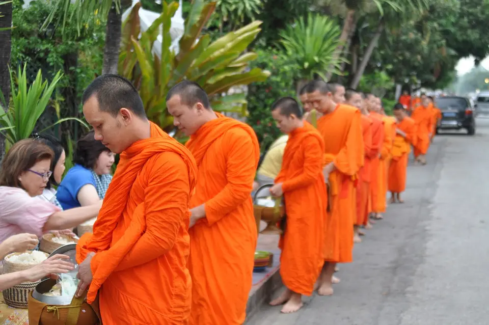Residents offering rice to monks on the morning alms round