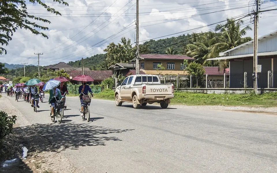 Cyclists on a road in Laos
