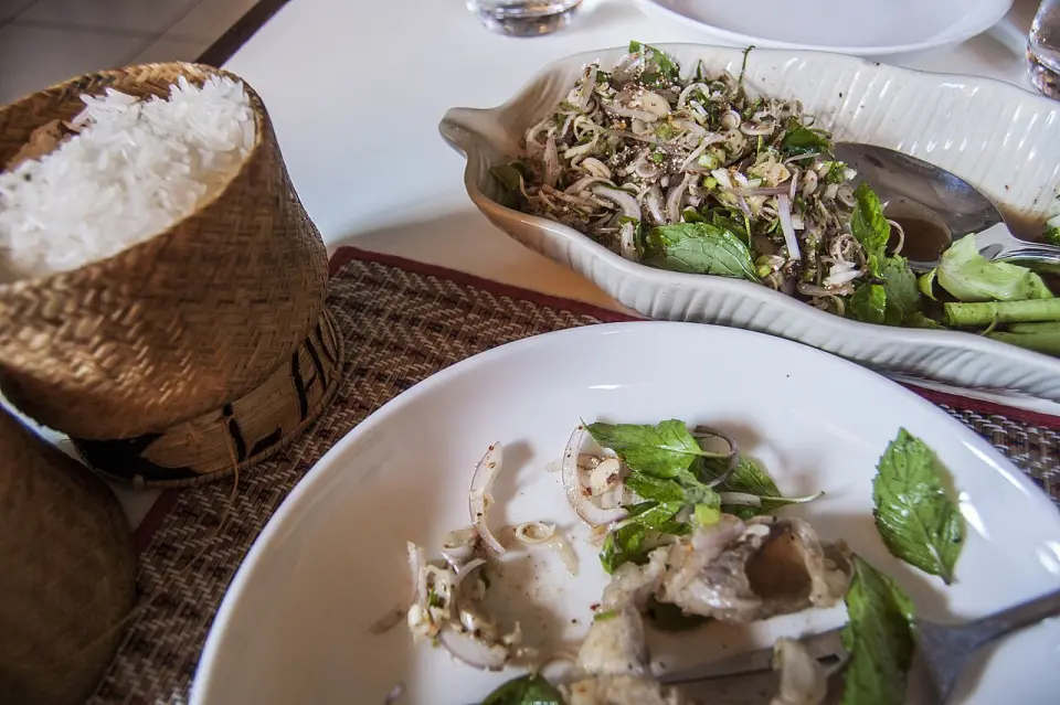 A Lao meal of sticky rice, soup and fresh herbs