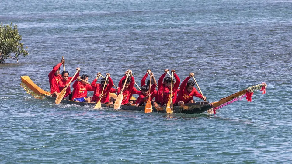 Rowers on a racing pirogue during a boat race in Laos
