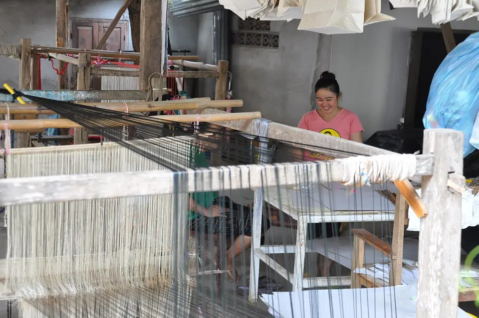 A weaver at a loom in Laos